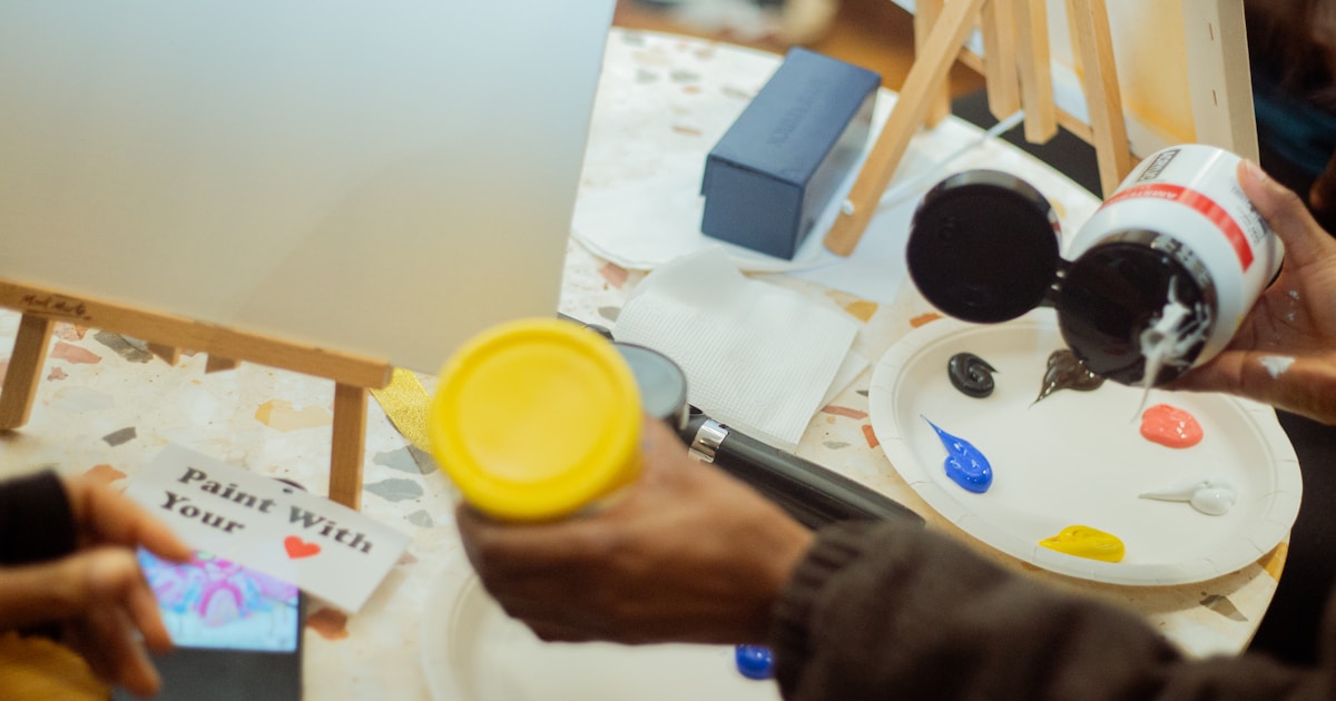 a person is painting a picture on a table