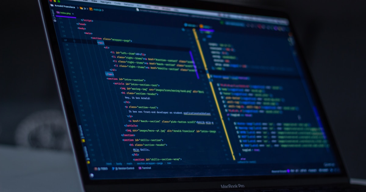 The Role of AI in Software Development: From Coding to Automation 2 turned-on MacBook Pro wit programming codes display
