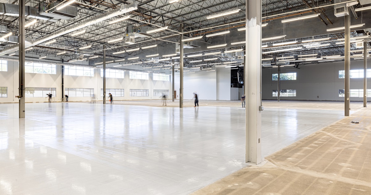 Empty, modern warehouse interior with polished concrete floor.