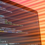 Laptop screen displaying code with colorful background