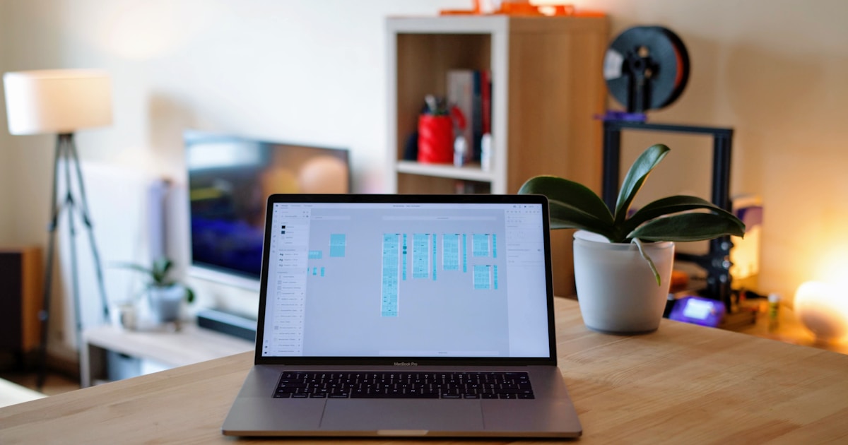 macbook pro on brown wooden table