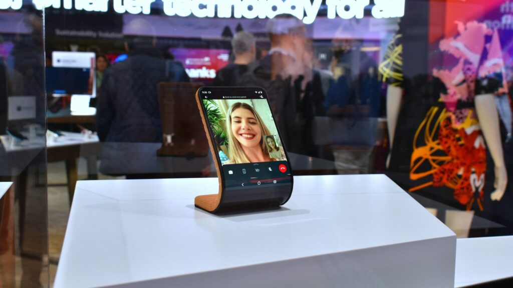 Smartphone displaying a video call on a stand.