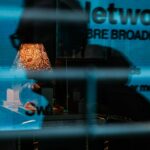 a reflection of a lamp in a glass window