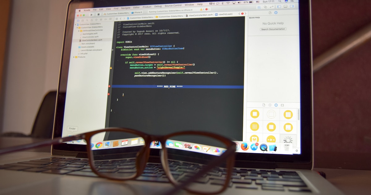 eyeglasses on turned on laptop