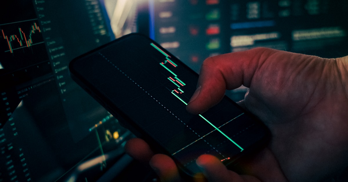 How to Reduce AML False Positives by 80% Using Machine Learning: A Practical Playbook 1 Trader analyzing stock market data on smartphone and phone