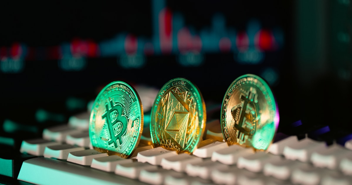 Cryptocurrency coins sit on a keyboard.