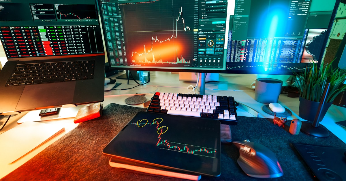A trader's desk is lit up with charts.