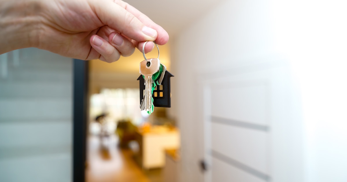 Real-World Use Cases of Blockchain Beyond Cryptocurrency 3 Holding house keys in front of the entrance.