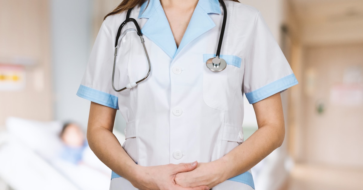 woman in white button up shirt and blue stethoscope