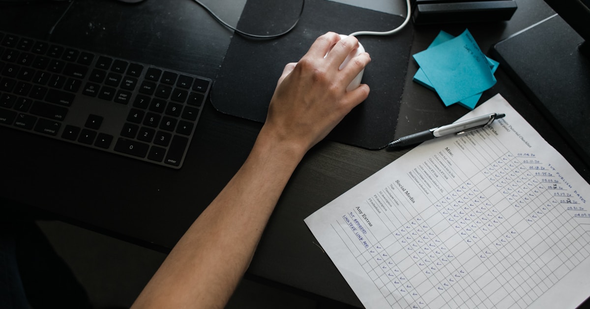 How to Reduce AML False Positives by 80% Using Machine Learning: A Practical Playbook 4 person holding black computer mouse
