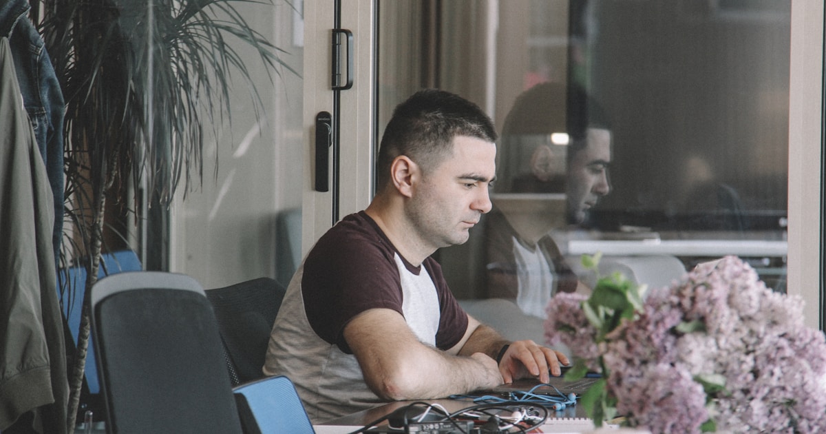 man sitting beside table
