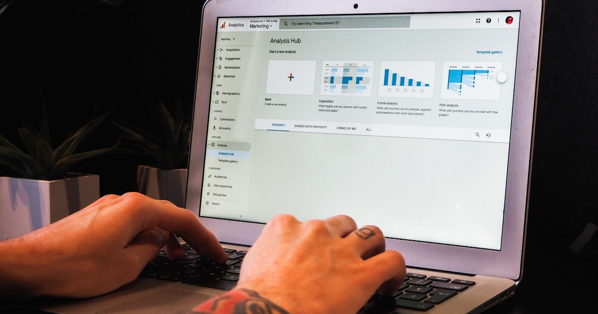 person using macbook pro on table