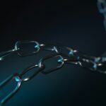 A metallic chain against a dark background