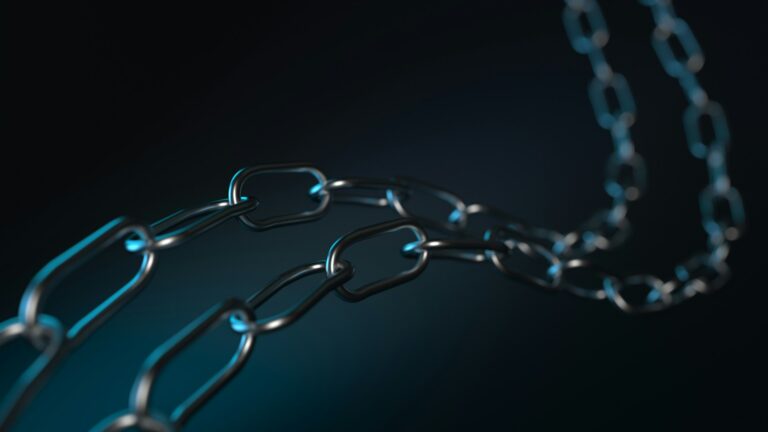 A metallic chain against a dark background