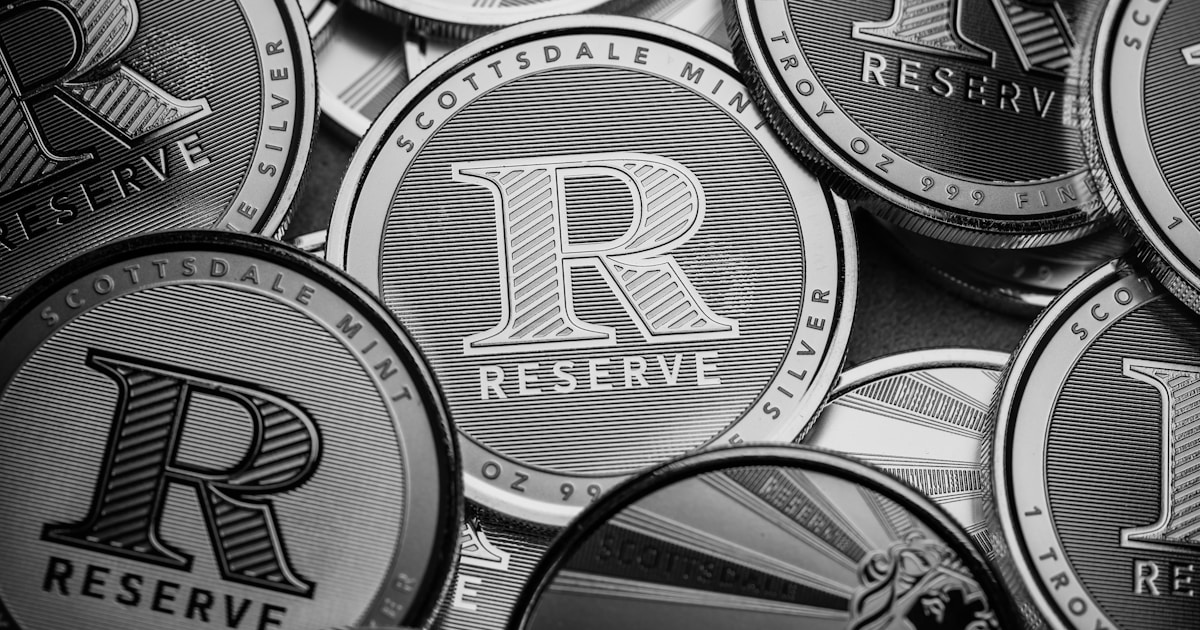 a pile of silver and black coins