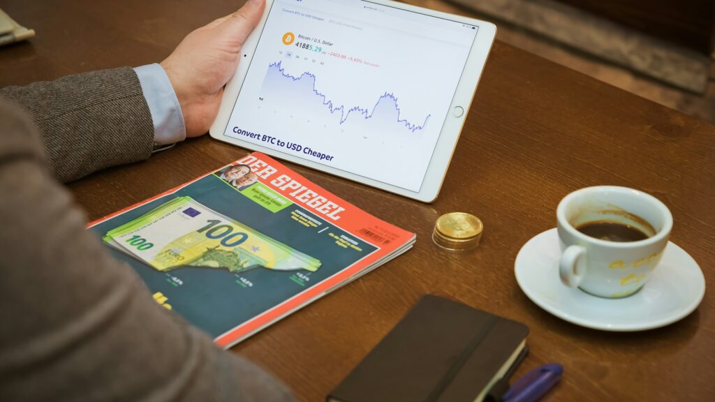 a person sitting at a table with a tablet and a cup of coffee