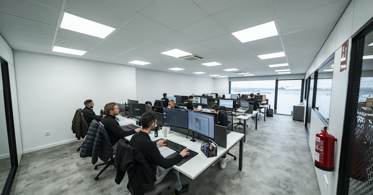 Future of Work with AI: How IT Pros Can Stay Relevant 1 Office workers are busy working on computers.