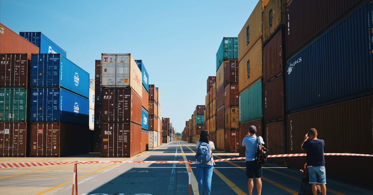 three people walking along a street