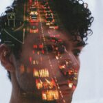 Double exposure of man's face and traffic lights