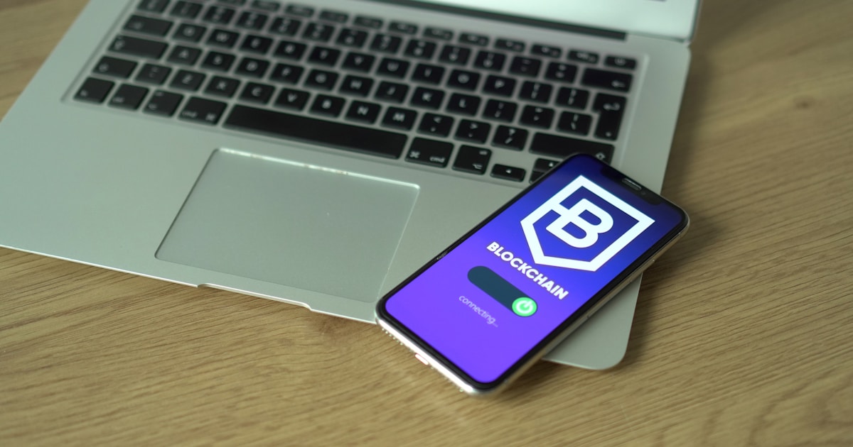 a cell phone sitting on top of a laptop computer