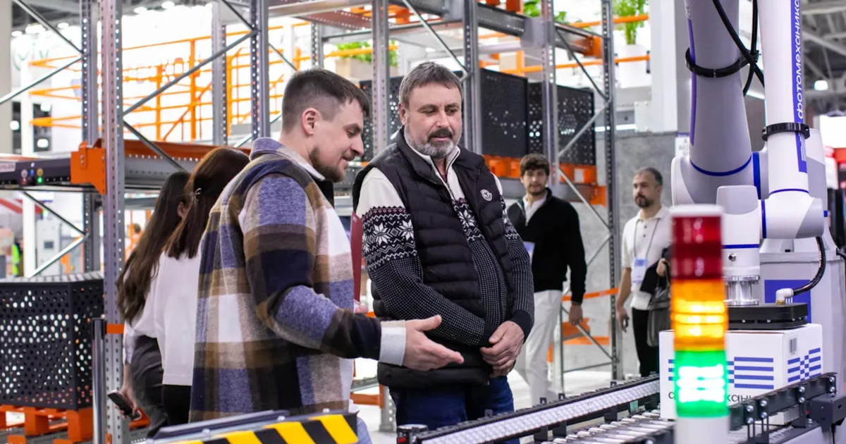 The Rise of Autonomous AI Agents: What They Are and Why They Matter 2 Men observe automated conveyor belt system in warehouse
