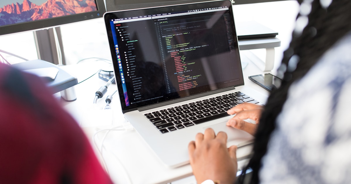 How Artificial Intelligence is Transforming the IT Industry in 2026 3 woman using MacBook