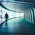 person walking along corridors ]